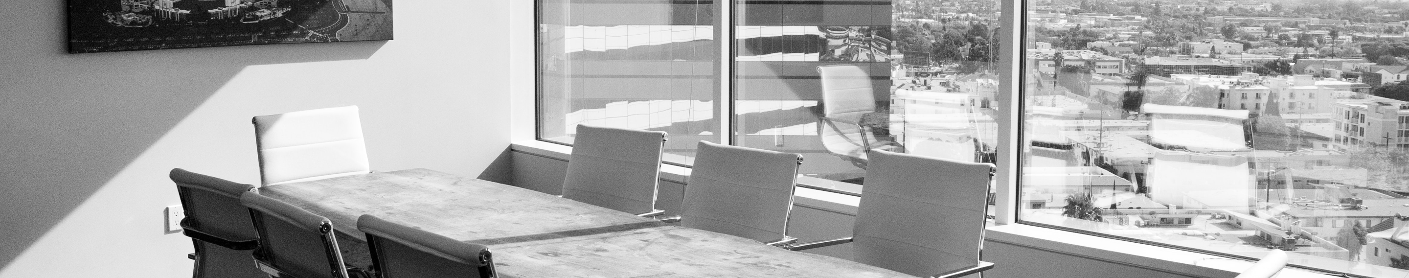 empty conference room showing table against glass wall